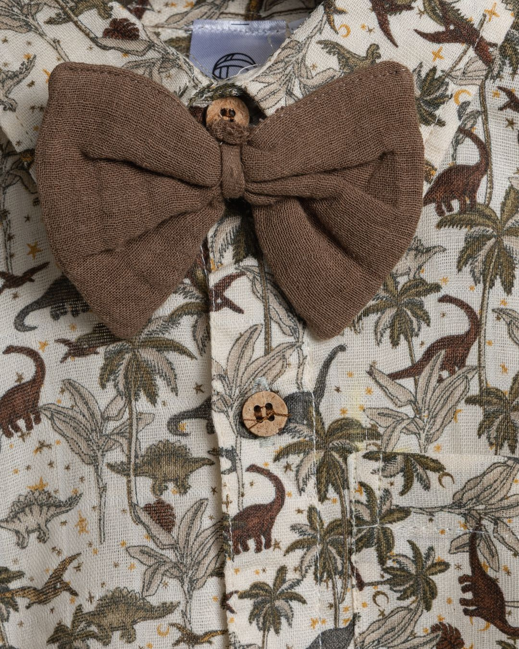 Close-up of Dinoro boys cotton co-ord set with cute dinosaur print and brown tie  – soft fabric detail.