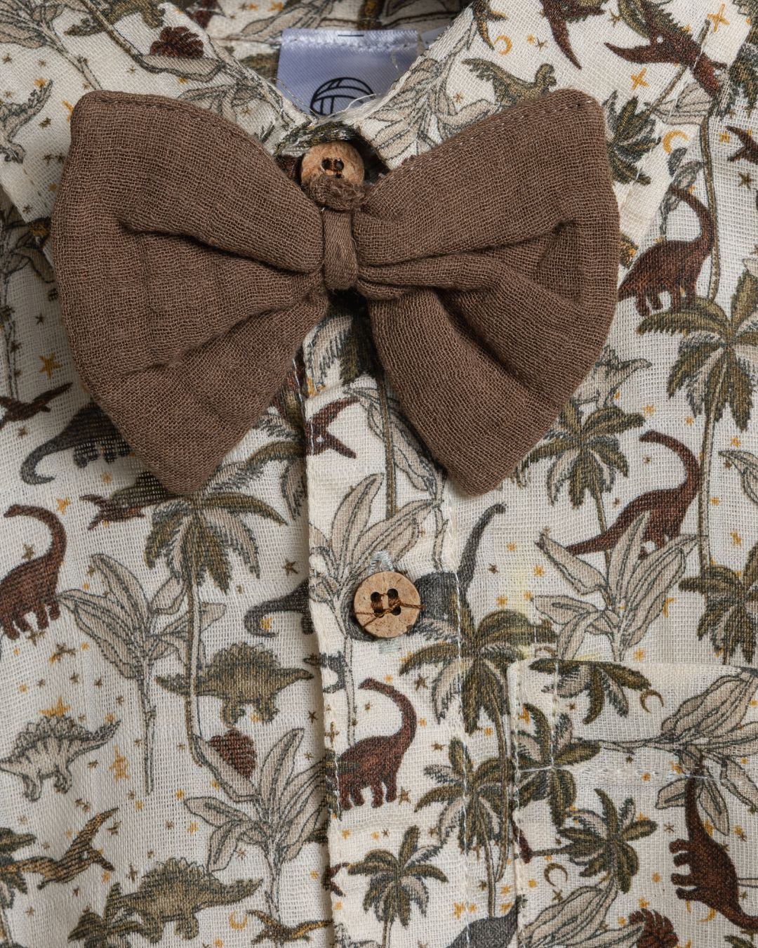 Close-up of Dinoro boys cotton co-ord set with cute dinosaur print and brown tie  – soft fabric detail.